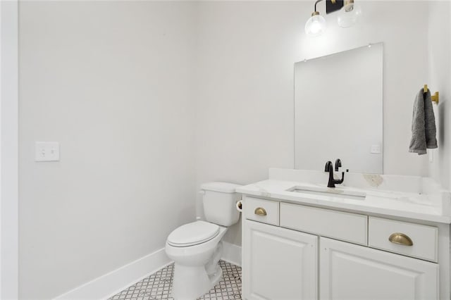 bathroom with tile patterned flooring, vanity, and toilet