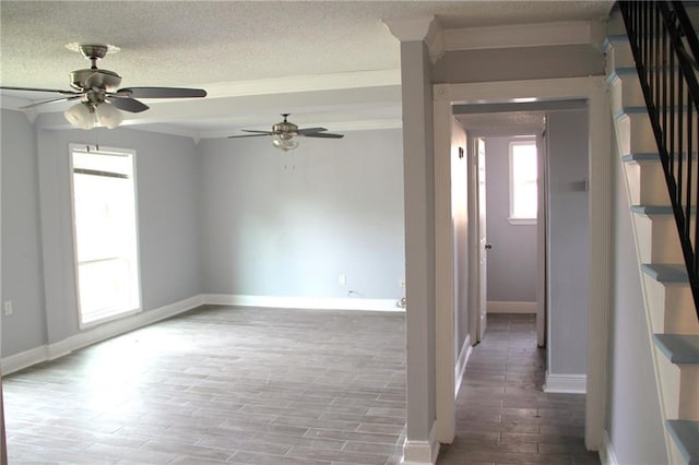 empty room featuring ceiling fan, crown molding, a textured ceiling, and light wood-type flooring