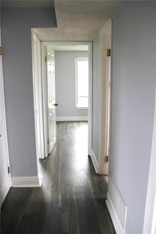 hallway with dark hardwood / wood-style floors