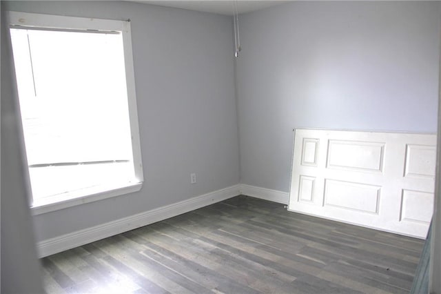 empty room featuring dark wood-type flooring