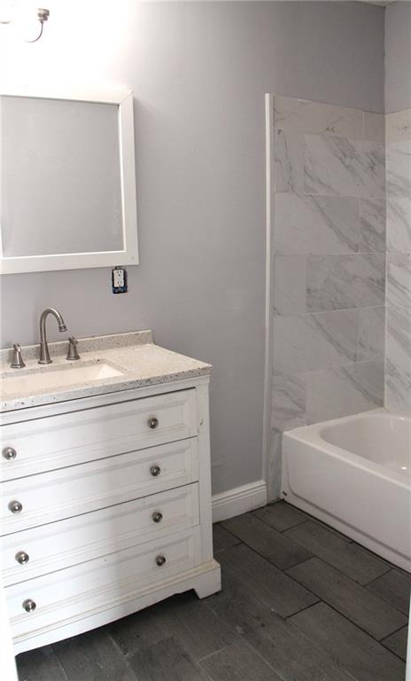 bathroom featuring bathing tub / shower combination and vanity