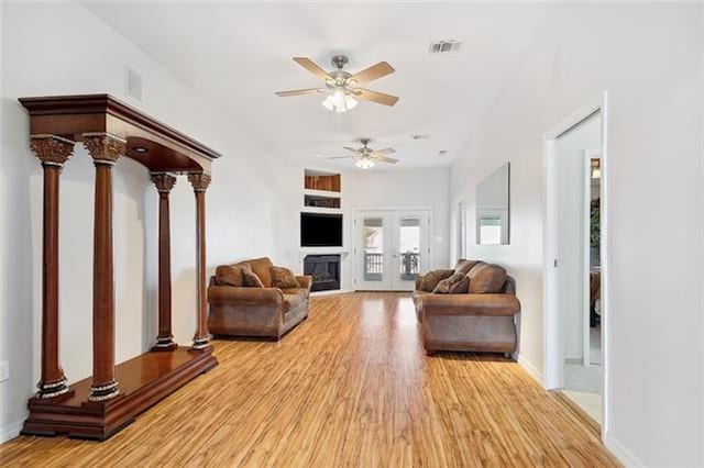 180 Lakeview Dr Unit A, Slidell, LA 70458 - living room featuring light wood-style floors, a ceiling fan, ornate columns, and baseboards