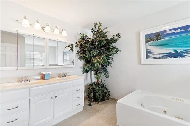 bathroom featuring vanity, tile patterned floors, and a tub