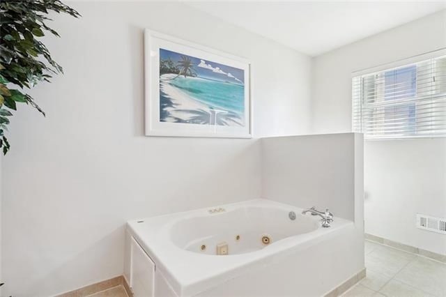 bathroom featuring tile patterned floors and a bathtub