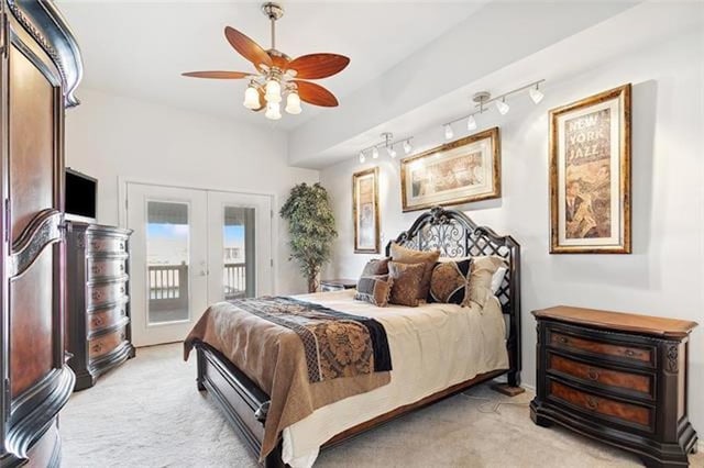 bedroom featuring ceiling fan, french doors, rail lighting, access to outside, and light carpet