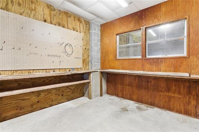 180 Lakeview Dr Unit A, Slidell, LA 70458 - interior space featuring unfinished concrete floors and wood walls