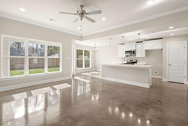 unfurnished living room with sink, ceiling fan with notable chandelier, and ornamental molding