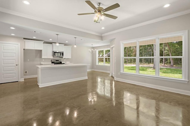 unfurnished living room with ceiling fan with notable chandelier, a wealth of natural light, crown molding, and sink