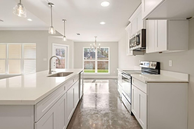 kitchen featuring white cabinets, sink, an island with sink, concrete flooring, and stainless steel appliances