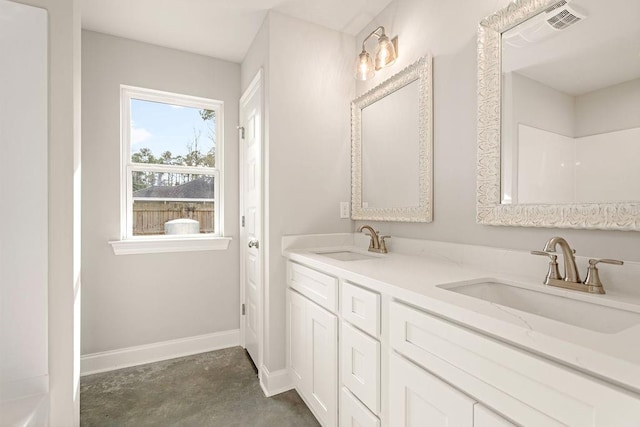 bathroom featuring vanity and concrete flooring