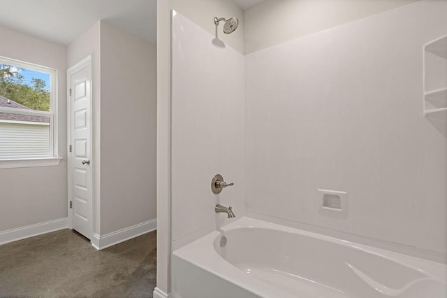 bathroom featuring concrete floors and tub / shower combination