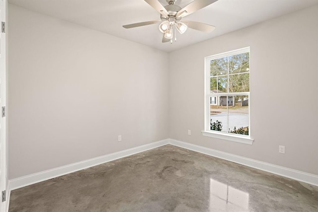 spare room with concrete flooring and ceiling fan