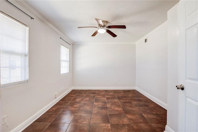 empty room with baseboards, visible vents, a ceiling fan, and crown molding