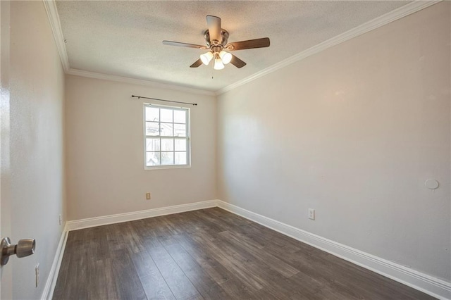 spare room featuring dark wood finished floors, ornamental molding, ceiling fan, a textured ceiling, and baseboards