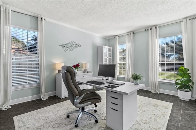office space featuring baseboards, a healthy amount of sunlight, and a textured ceiling