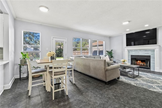 living room with a textured ceiling, crown molding, and dark tile patterned flooring