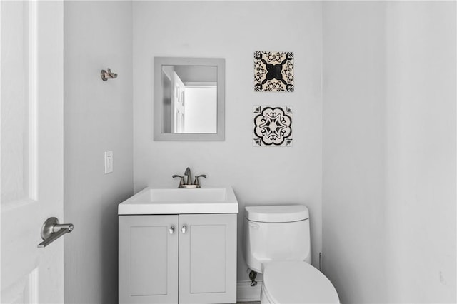 bathroom featuring toilet and vanity