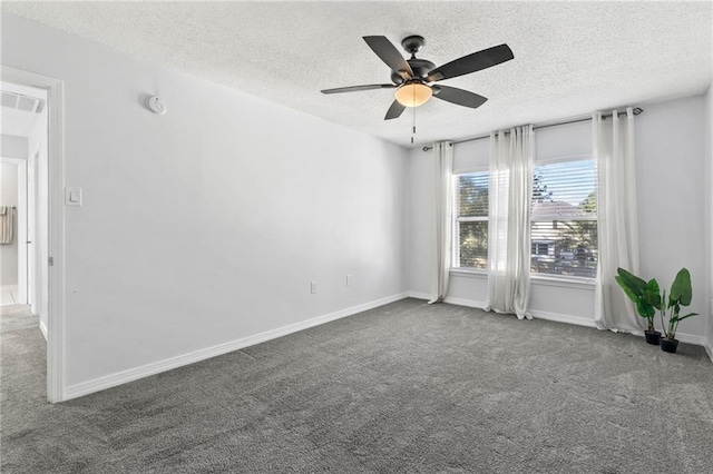 spare room featuring a textured ceiling, carpet floors, and ceiling fan