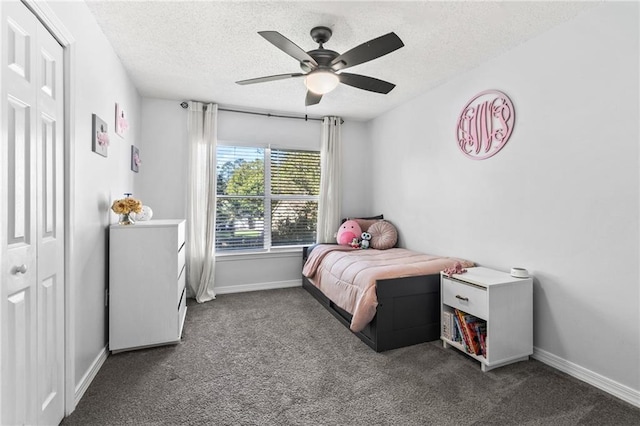 carpeted bedroom with ceiling fan, a textured ceiling, and a closet