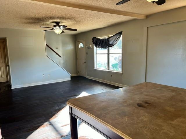 foyer featuring ceiling fan, dark hardwood / wood-style flooring, and a textured ceiling