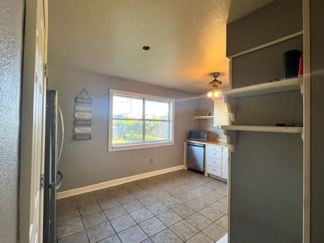 kitchen featuring tile patterned flooring and stainless steel appliances