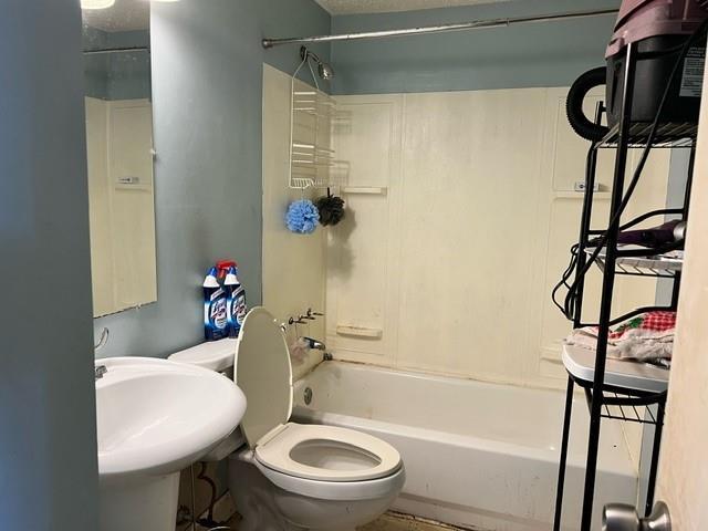 full bathroom featuring toilet, sink, and bathtub / shower combination