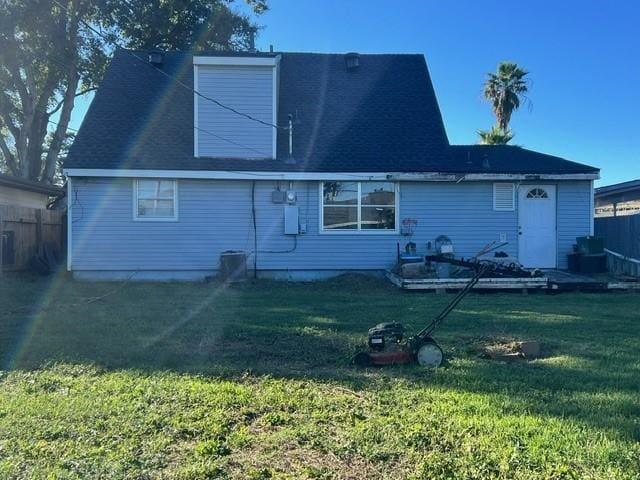 back of house with a lawn