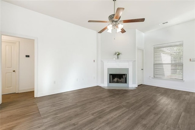 unfurnished living room with ceiling fan and dark hardwood / wood-style flooring