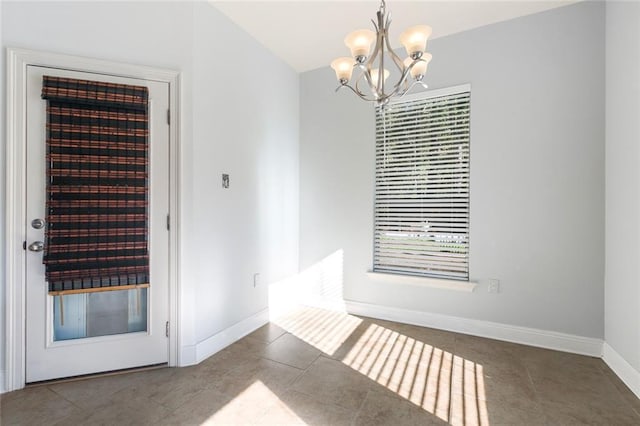 unfurnished dining area with tile patterned flooring and a notable chandelier