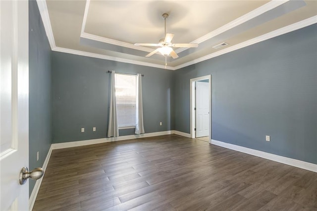 spare room featuring dark hardwood / wood-style floors, ceiling fan, and ornamental molding