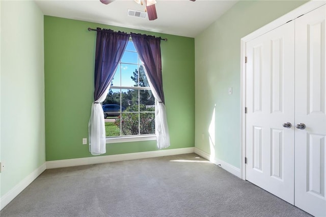 unfurnished room featuring light carpet and ceiling fan