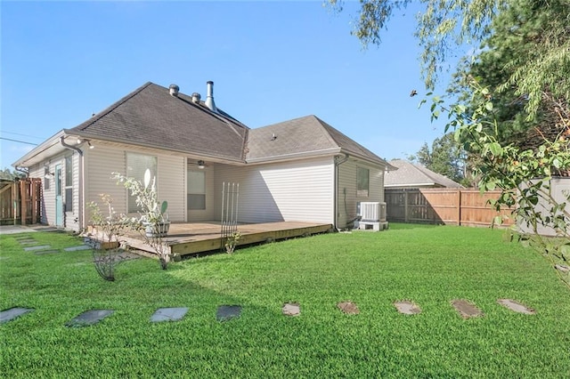 back of house with a lawn, cooling unit, and a wooden deck