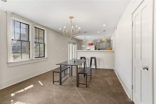 tiled dining area featuring a wealth of natural light and a notable chandelier