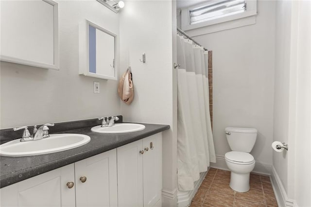 bathroom featuring curtained shower, vanity, and toilet