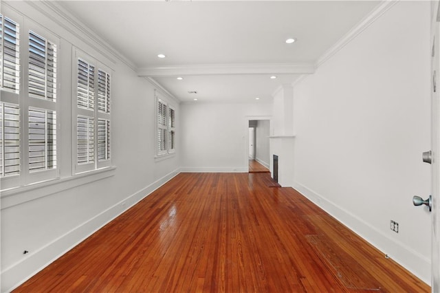 unfurnished living room with hardwood / wood-style flooring and ornamental molding