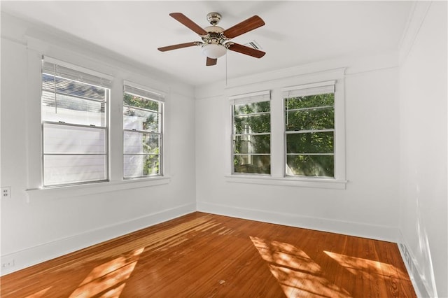 unfurnished room featuring wood-type flooring, ceiling fan, and crown molding