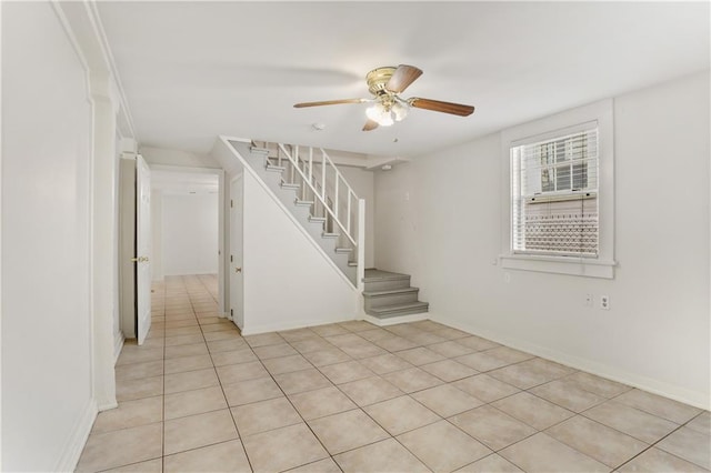 empty room featuring light tile patterned floors and ceiling fan