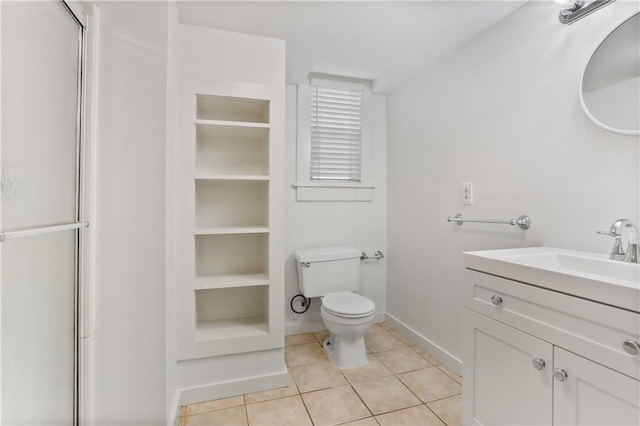 bathroom featuring tile patterned floors, vanity, and toilet