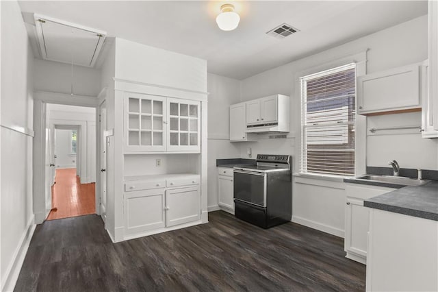 kitchen with electric range oven, sink, white cabinetry, and dark wood-type flooring