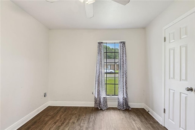 spare room with ceiling fan and dark hardwood / wood-style floors