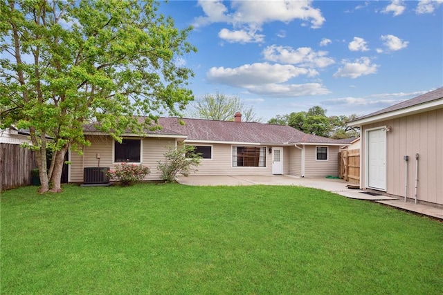 back of house with central AC, a yard, and a patio area