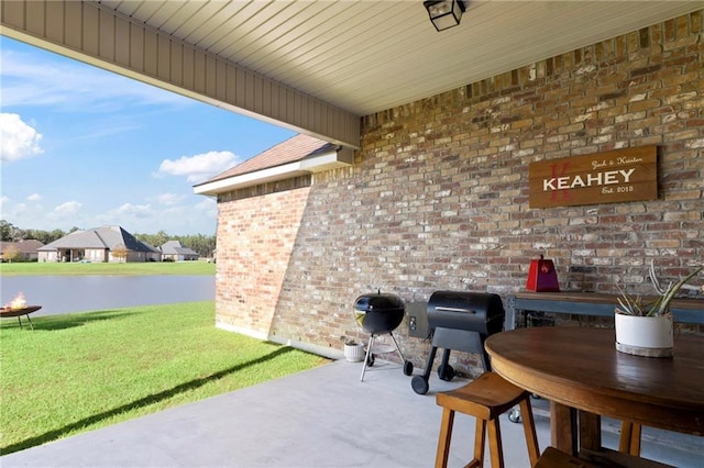 view of patio / terrace featuring a water view and grilling area