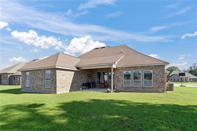 back of property with a lawn, cooling unit, and a patio