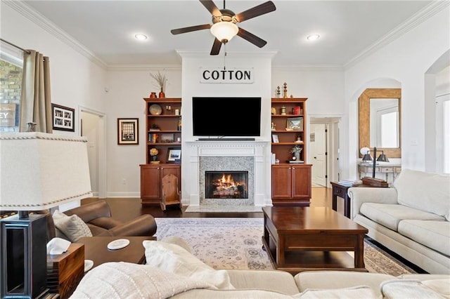 living room featuring ceiling fan and ornamental molding