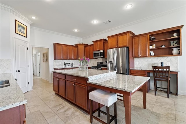 kitchen featuring light stone countertops, a center island, and stainless steel appliances