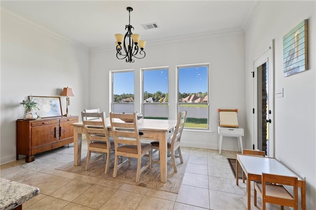 dining room featuring light tile patterned floors, crown molding, and a chandelier