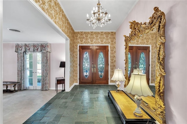 entryway featuring crown molding, french doors, and a notable chandelier