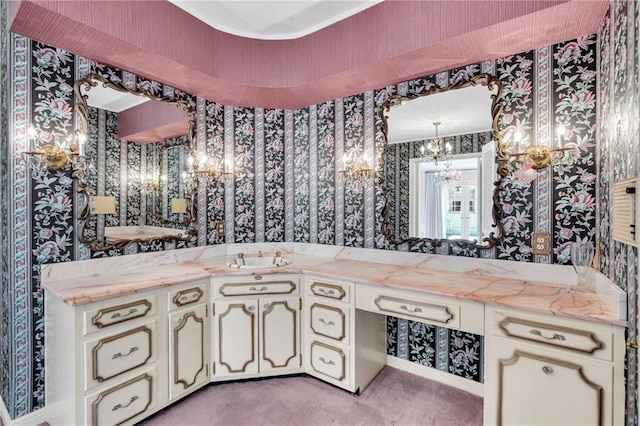 bathroom with a notable chandelier and vanity