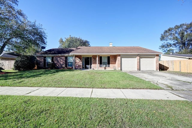 ranch-style home with aphalt driveway, an attached garage, brick siding, fence, and a front yard