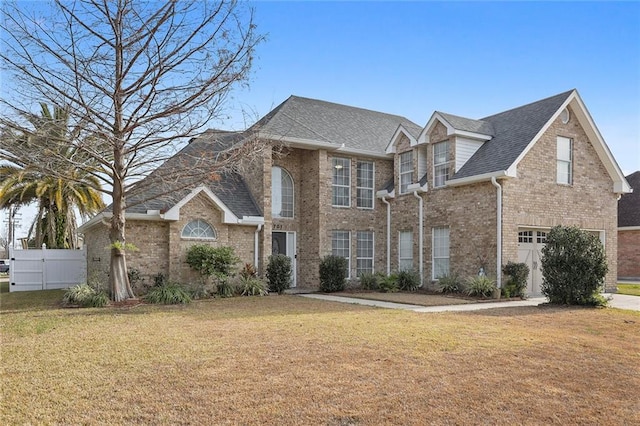 view of front of house featuring a front lawn and a garage